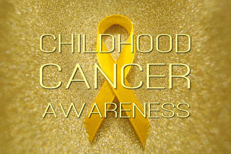 Gold ribbon for children as a symbol of childhood cancer awareness.の写真素材