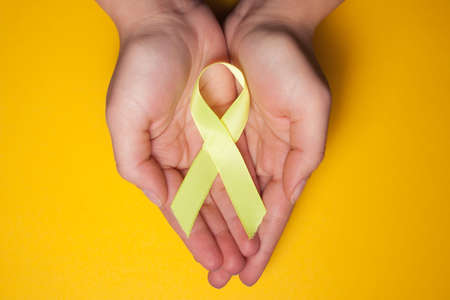 Gold ribbon for children as a symbol of childhood cancer awareness.