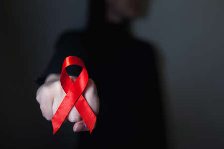 Red AIDS awareness ribbon on blackの写真素材