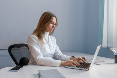 Young female doctor talking to patient online from medical office.の写真素材