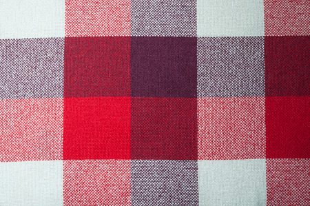 Textured fabric with a pattern of squares of red, purple and white