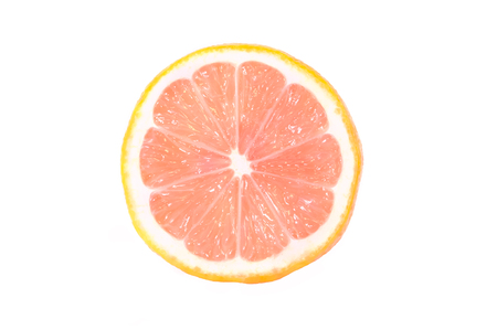 One half of a ripe lemon with a pink flesh is isolated on a white background.の写真素材