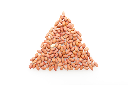 The shape of a triangle of peeled peas on a white table close-up