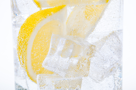 Ice, lemon slices and crystal clear water in a glass.の写真素材