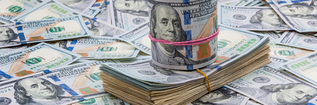 Background from dollars. Notes of one hundred American dollars are scattered across the background