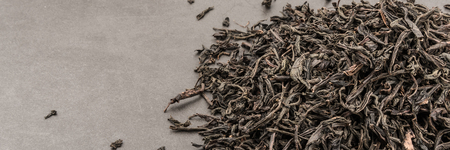 Dried tea is poured scattered on a grey textured backgroundの写真素材