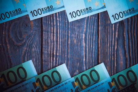 Euro banknotes lie frame at wooden backgroundの写真素材