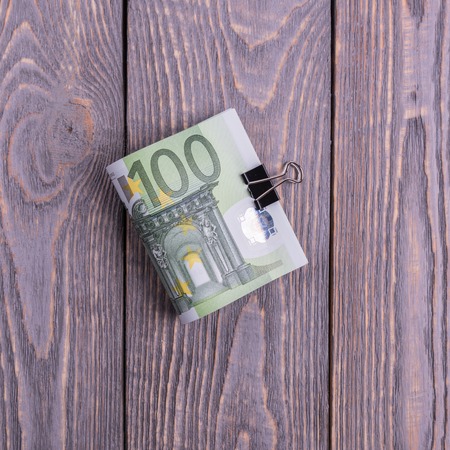 Euro cash banknotes on a dark wooden backgroundの写真素材