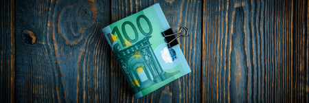 Euro cash banknotes on a dark wooden backgroundの写真素材