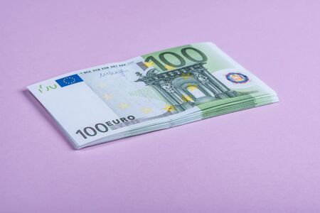 Euro cash on a lilac, purple and pink background. Euro Money Banknotes. Euro Money. Euro bill. Place for text.の写真素材