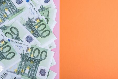 Euro cash on a pink and orange background. Euro Money Banknotes. Euro Money. Euro bill. Place for text.の写真素材