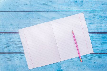 Notepad with pencil on wood board background.using wallpaper for education, business photo.Take note...