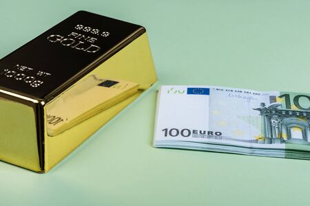 Euro cash and gold bar on a green background. Banknotes. Money. Bill. Ingot. Bullionの写真素材