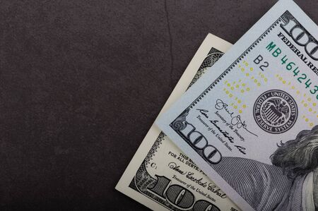 One hundred dollar bills on a gray backgroundの写真素材