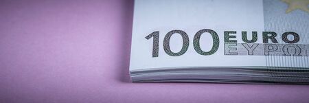 Euro cash on a lilac, purple and pink background. Euro Money Banknotes. Euro Money. Euro bill. Place for textの写真素材
