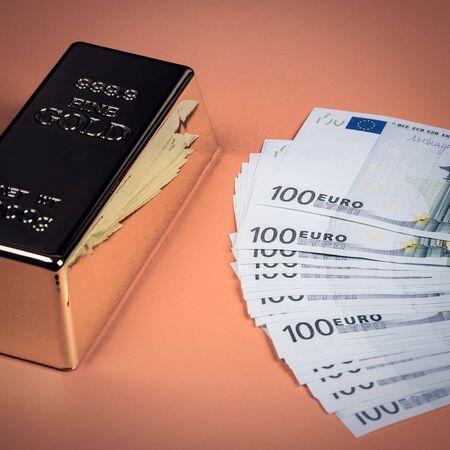 Euro cash and gold bar on a orange background. Banknotes. Money. Bill. Ingot. Bullion