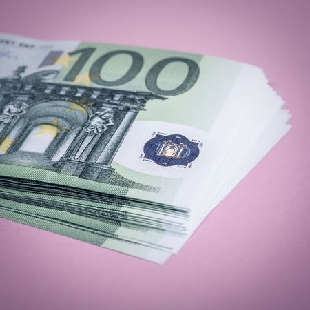 Euro cash on a lilac, purple and pink background. Euro Money Banknotes. Euro Money. Euro bill. Place...