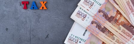 Big stack of Russian money banknotes of five thousand rubles lying fan on a grey cement backgroundの写真素材