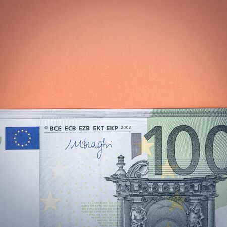 Euro cash on a pink and orange background. Euro Money Banknotes. Euro Money. Euro bill. Place for...