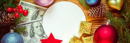 Christmas tree with decoration on a wooden board. Christmas toy. New year. Greeting card and dollarsの写真素材