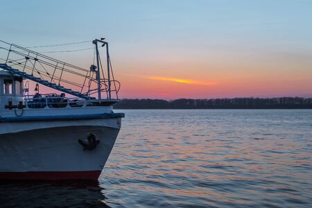 Evening, sunset, river on the pier pleasure boatの写真素材