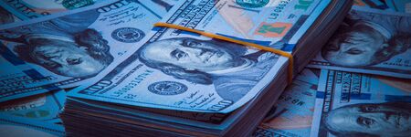 The background of a one hundred dollar bill. Style blue light