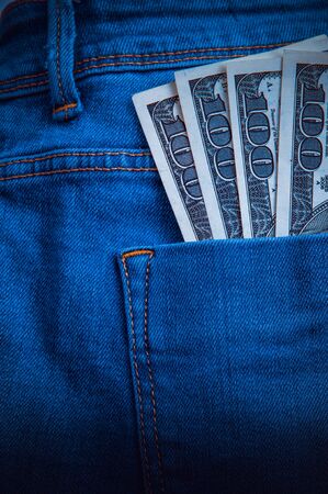 A hundred dollars in the back pocket of the jeansの写真素材