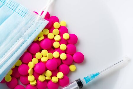 Medical mask surgical protective virus, flu, disease, textile filter, tablets, pills and syringe. Isolated on a white background.の写真素材