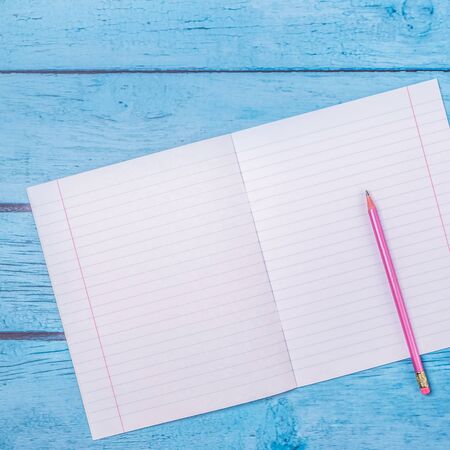Notepad with pencil on wood board background.using wallpaper for education, business photo.Take note of the product for book with paper and concept, object or copy space. Flat lay, top view office table deskの写真素材
