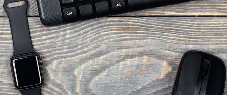 Workplace smart watch, keyboard, mouse, all black, brutal accessories, on a table made of textured...