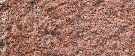 Background granite is a red stone with small black and white spots on the entire surface. Texture for an inscription, text, or logo.の写真素材