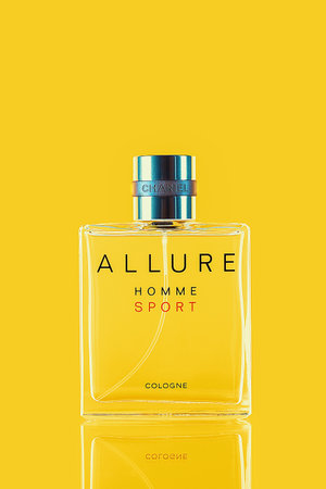 A bottle of Chanel perfume on a uniform yellow background, with a reflection of the lower part. Allure mens perfume series. 2020-07-05 Samara.のeditorial素材