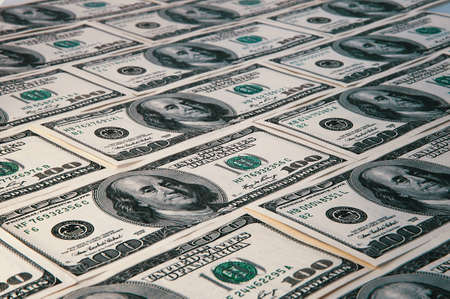 Banknotes of dollars are stacked in a row.の写真素材