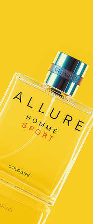 A bottle of Chanel perfume on a uniform yellow background, with a reflection of the lower part. Allure mens perfume series. 2020-07-05 Samara.のeditorial素材