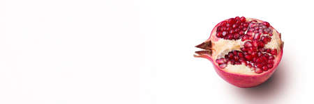 Garnet isolated part on a white background close-up with shadow. Fresh pomegranate. Juicy pomegranate. Delicious pomegranate. Place for advertising, logo, lettering,の写真素材