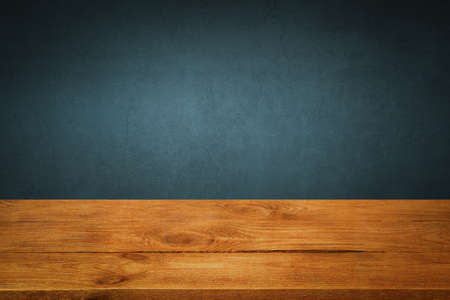 The background is blank wooden boards and a textured plastered wall with lighting and vignetting.の写真素材