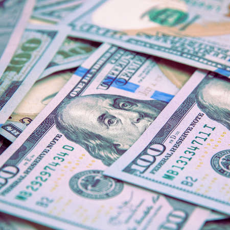 Cash hundred-dollar bills, banknotes are scattered dollar background image.