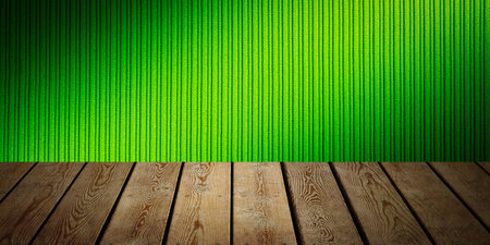 The background is blank wooden boards and a textured striped wall with gradient lighting and vignetting.の写真素材