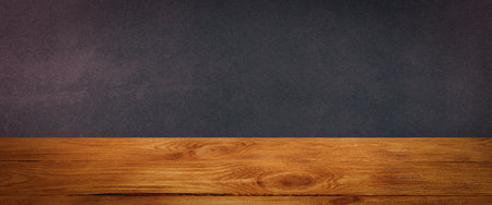 The background is blank wooden boards and a textured plastered wall with lighting and vignetting.の写真素材