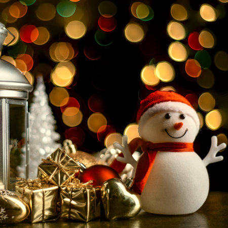 Christmas card: a snowman, a lantern with candles, bright shiny boxes with gifts and blurry lights in the background.の写真素材