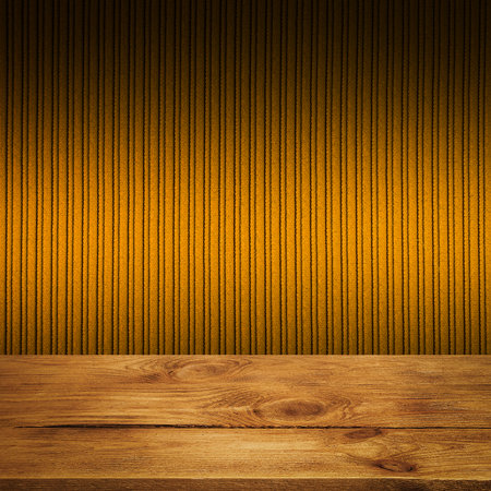 The background is blank wooden boards and a textured striped wall with gradient lighting and vignetting.の写真素材