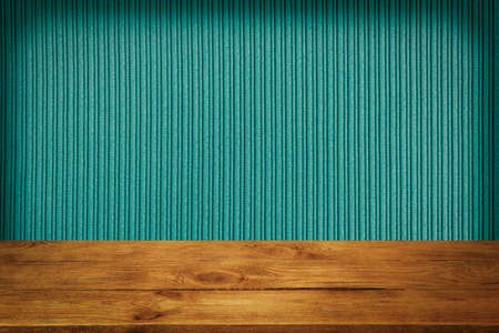 The background is blank wooden boards and a textured striped wall with gradient lighting and vignetting.の写真素材