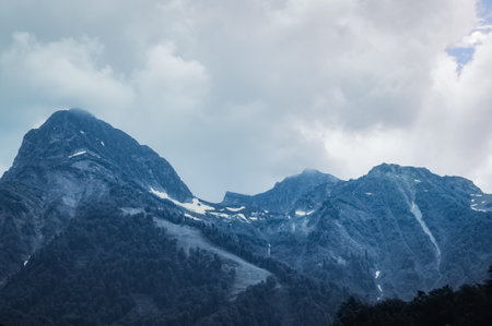 Mountain landscape. Snowy peak. Fog and aerial perspective
