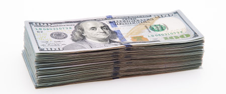 A large stack of hundred-dollar cash bills on a white background. Isolated. Layout, mockup, place...