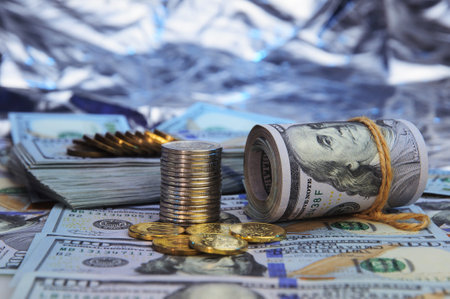 Stacks of coins against the background of hundred-dollar bills are scattered throughout the space....