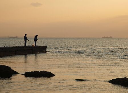 fishmen at the sea before sunriseの写真素材
