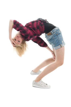 Beautiful teenage girl in odd fashion pose. Isolated on whiteの写真素材