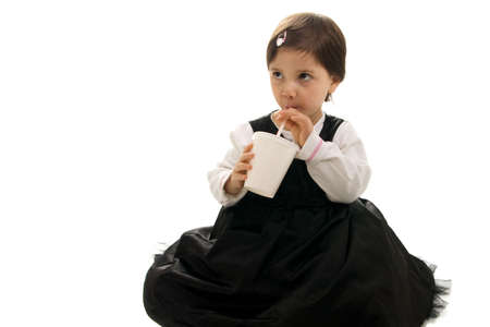 Cute little girl drinking. Isolated on whiteの写真素材
