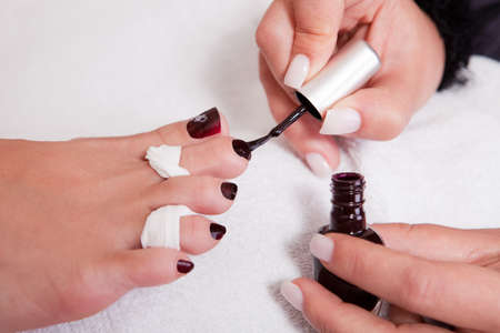 Beautician working on toenails