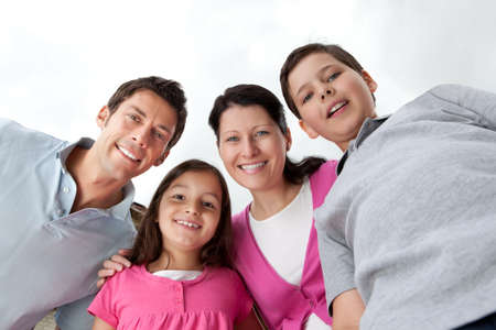 Portrait of beautiful young family together against skyの写真素材